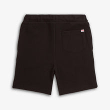 Load image into Gallery viewer, Black shorts with a small logo on a light gray background