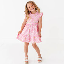 Load image into Gallery viewer, Young girl wearing a pink dress with puppies on a white background