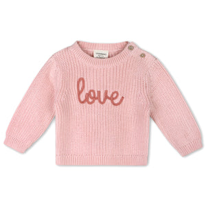 Pink sweater with 'love' text on a white background