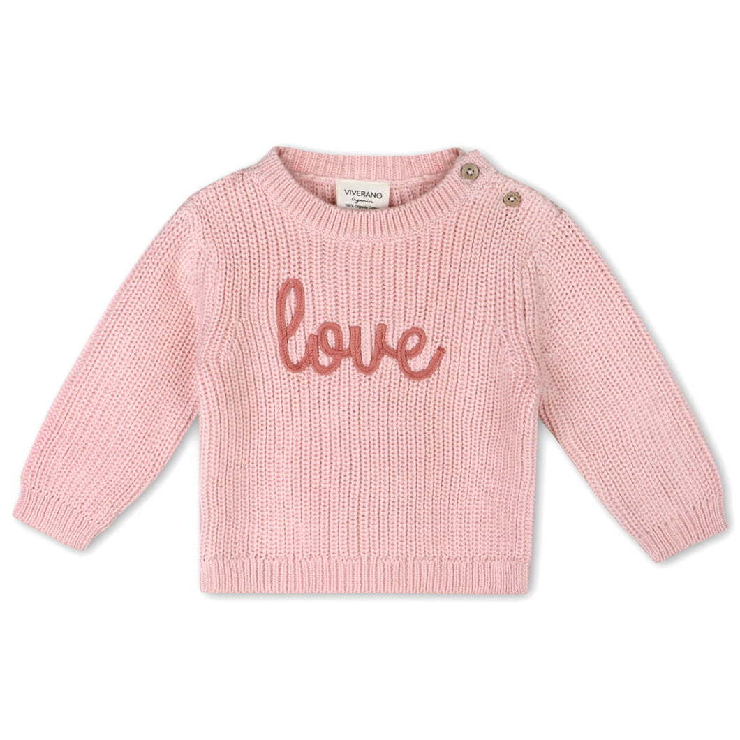 Pink sweater with 'love' text on a white background