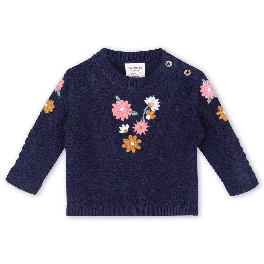 Navy blue sweater with floral patterns on a white background