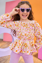 Load image into Gallery viewer, Young girl wearing a floral blouse and heart-shaped sunglasses against a colorful background
