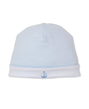 Load image into Gallery viewer, Light blue baby hat with a small sailboat emblem on a white background
