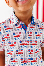 Load image into Gallery viewer, Child wearing a patterned shirt with red cars and blue stripes.
